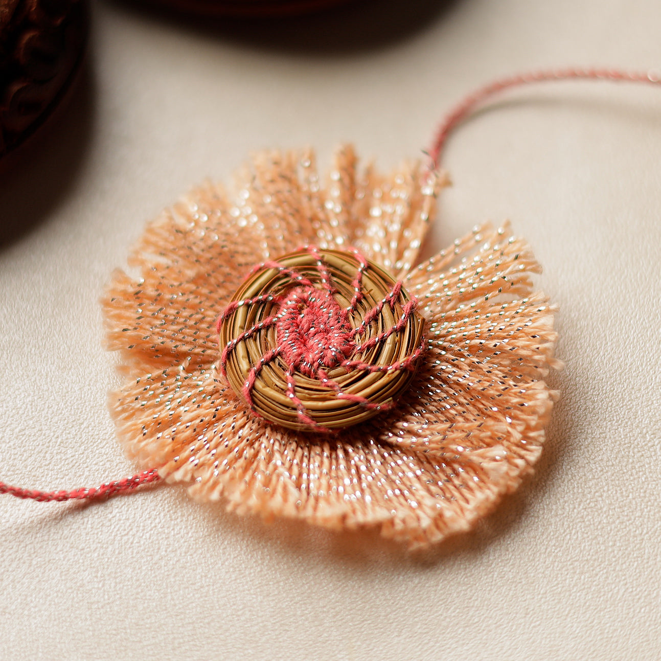 Handcrafted Pine Needles Hibiscus Rakhi by Pirul