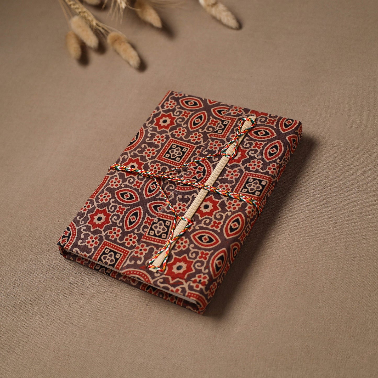 Handmade paper notebook in ajrakh fabric cover with thread