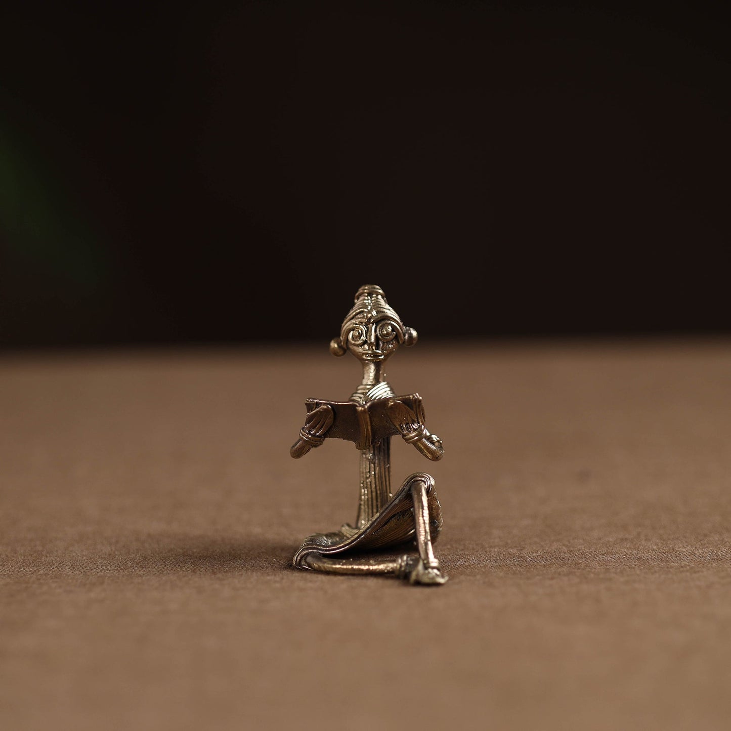 Sitting lady with reading book tribal odisha dokra art