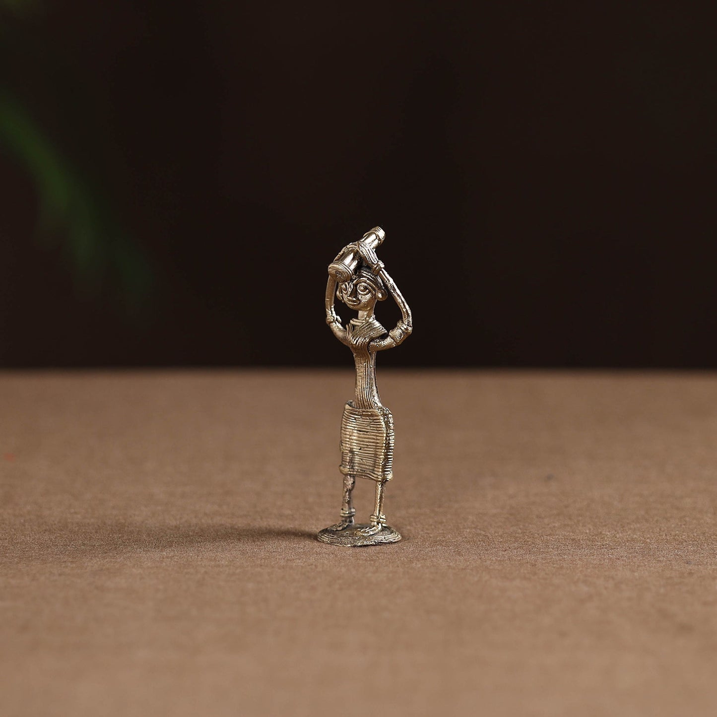 Standing lady with holding wooden gate tribal odisha dokra