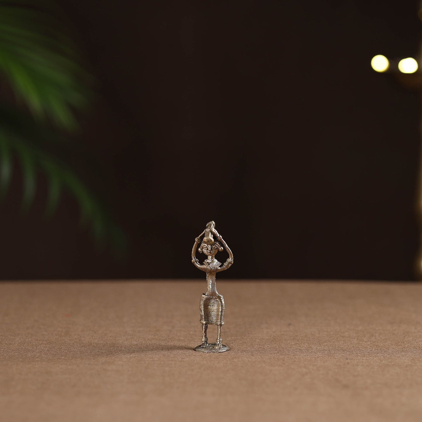 Standing lady with holding wooden gate tribal odisha dokra