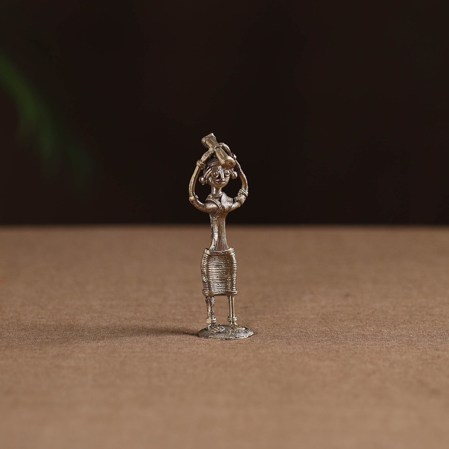Standing lady with holding wooden gate tribal odisha dokra