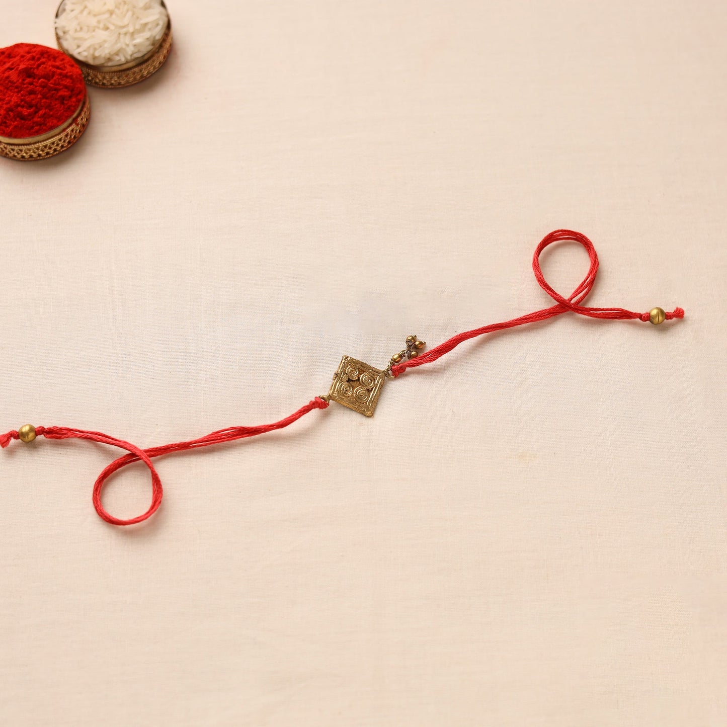 Tribal Dokra Craft Brass Rakhi by Miharu