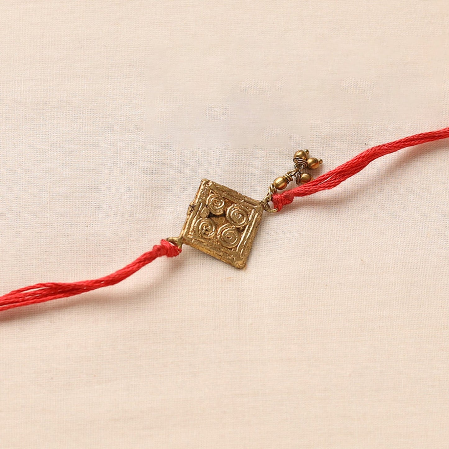 Tribal Dokra Craft Brass Rakhi by Miharu