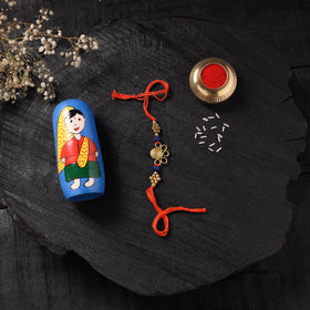 Orange - Handcrafted Tribal Dokra Brass Thread Rakhi with Banaras Wood Doll Box 05