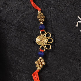 Orange - Handcrafted Tribal Dokra Brass Thread Rakhi with Banaras Wood Doll Box 05