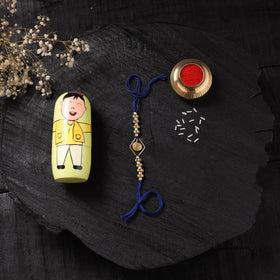 Blue - Handcrafted Tribal Dokra Brass Thread Rakhi with Banaras Wood Doll Box 09