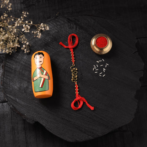 Red - Handcrafted Tribal Dokra Brass Thread Rakhi with Banaras Wood Doll Box 11