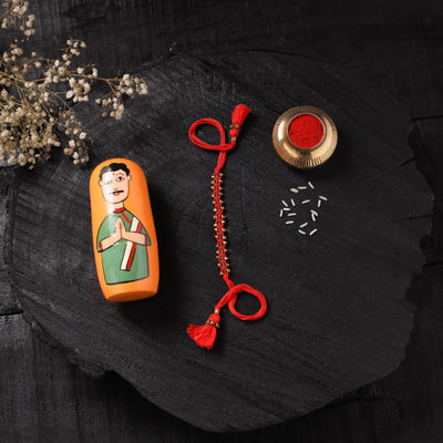 Red - Handcrafted Tribal Dokra Brass Thread Rakhi with Banaras Wood Doll Box 16