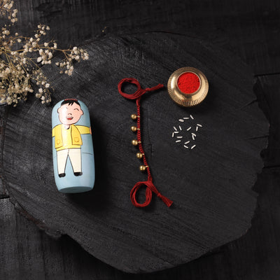 Red - Handcrafted Tribal Dokra Brass Thread Rakhi with Banaras Wood Doll Box 13