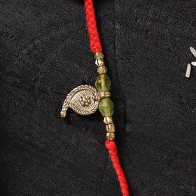 Red - Handcrafted Tribal Dokra Brass Thread Rakhi with Banaras Wood Doll Box 23