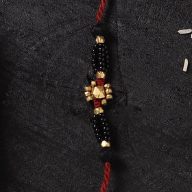 Red - Handcrafted Tribal Dokra Brass Thread Rakhi with Banaras Wood Doll Box 38