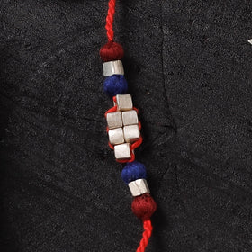 Red - Handcrafted Tribal Dokra Brass Thread Rakhi with Banaras Wood Doll Box 40