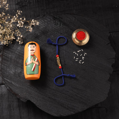 Blue - Handcrafted Tribal Dokra Brass Thread Rakhi with Banaras Wood Doll Box 41