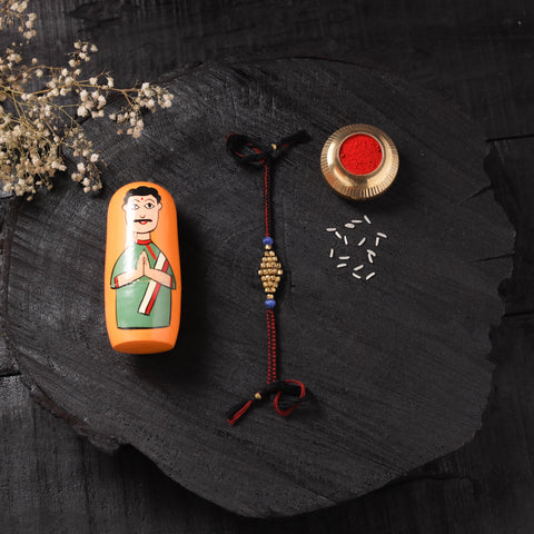 Red - Handcrafted Tribal Dokra Brass Thread Rakhi with Banaras Wood Doll Box 44