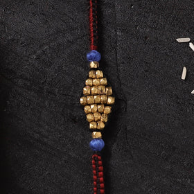 Red - Handcrafted Tribal Dokra Brass Thread Rakhi with Banaras Wood Doll Box 44