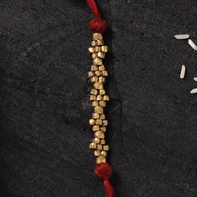Red - Handcrafted Tribal Dokra Brass Thread Rakhi with Banaras Wood Doll Box 45