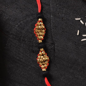 Red - Handcrafted Tribal Dokra Brass Thread Rakhi with Banaras Wood Doll Box 46