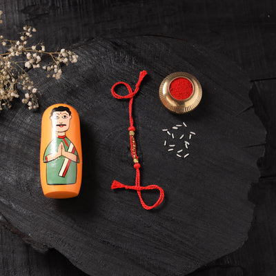 Red - Handcrafted Tribal Dokra Brass Thread Rakhi with Banaras Wood Doll Box 47