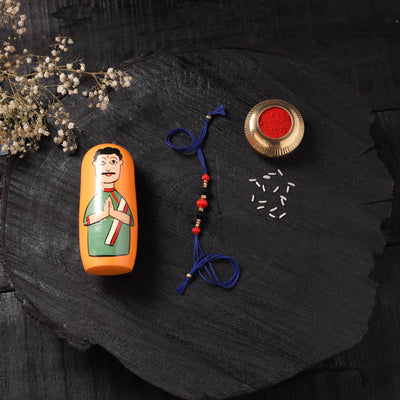 Blue - Handcrafted Tribal Dokra Brass Thread Rakhi with Banaras Wood Doll Box 48