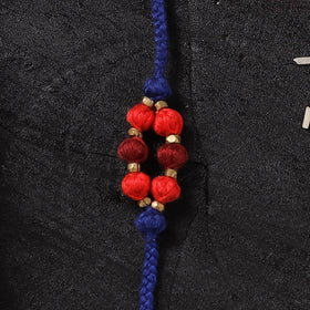 Blue - Handcrafted Tribal Dokra Brass Thread Rakhi with Banaras Wood Doll Box 50