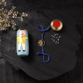 Blue - Handcrafted Tribal Dokra Brass Thread Rakhi with Banaras Wood Doll Box 56