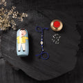 Blue - Handcrafted Tribal Dokra Brass Thread Rakhi with Banaras Wood Doll Box 61