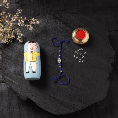Blue - Handcrafted Tribal Dokra Brass Thread Rakhi with Banaras Wood Doll Box 61
