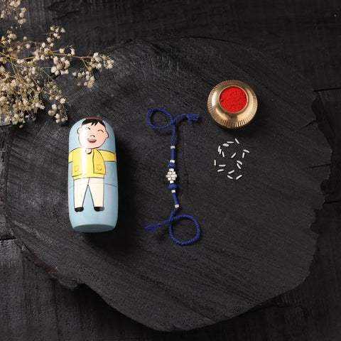Blue - Handcrafted Tribal Dokra Brass Thread Rakhi with Banaras Wood Doll Box 61
