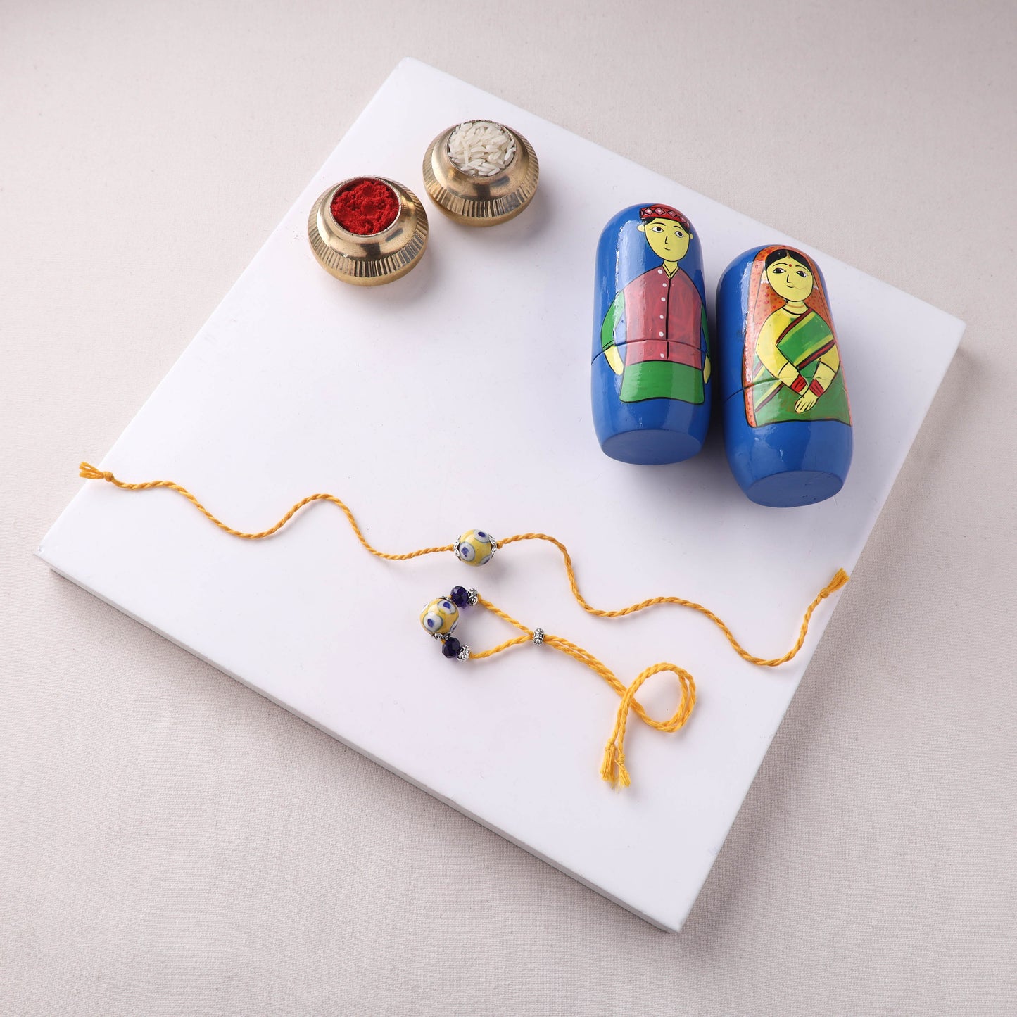 Yellow - Handmade Blue Pottery & GS Bead Work Bhaiya Bhabhi Rakhi Set with Banaras Wood Dolls Box 23