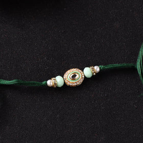 Handcrafted Kundan Beaded Rakhi for Brother with Potli 39