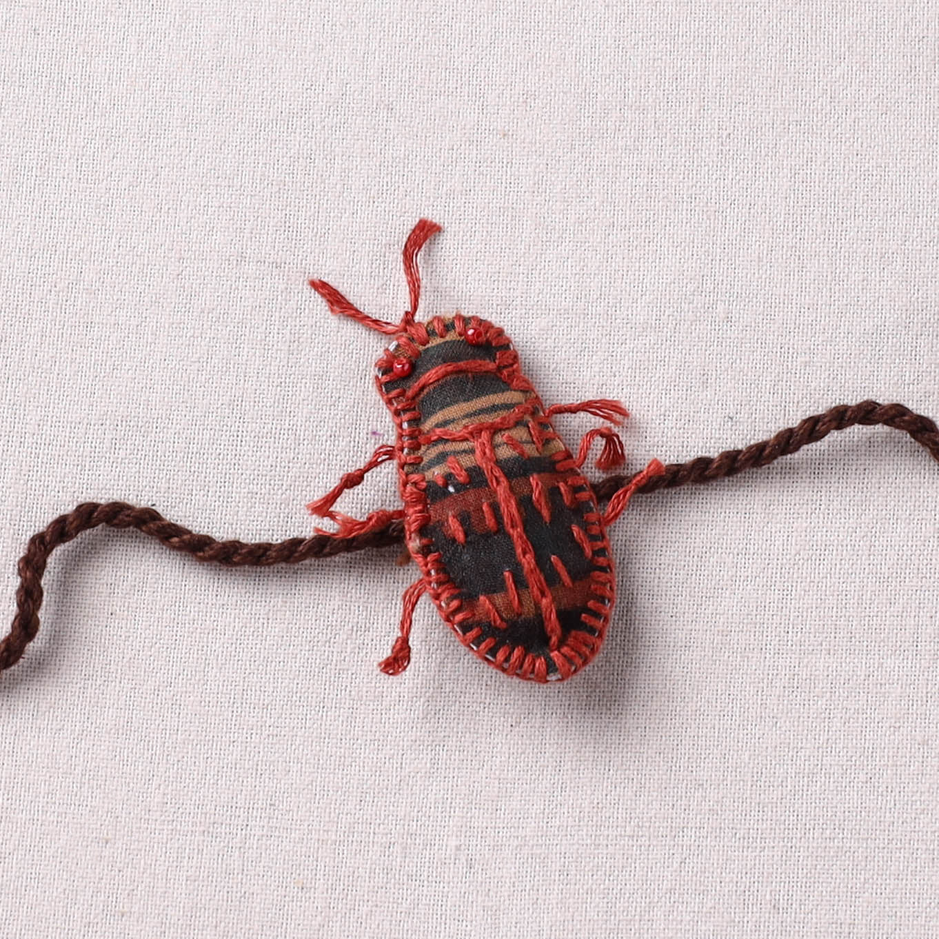 Cockroach - Reusable Handmade Threadwork Rakhi with Potli 05
