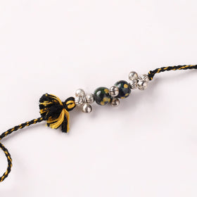 Handcrafted Patwa Threadwork Blue Pottery Beads Rakhi with Potli 02