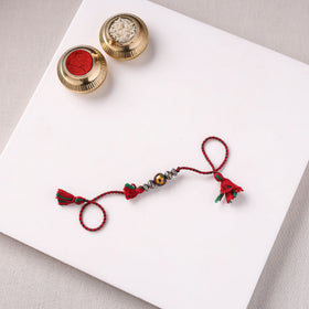 Handcrafted Patwa Threadwork Blue Pottery Beads Rakhi with Potli 03