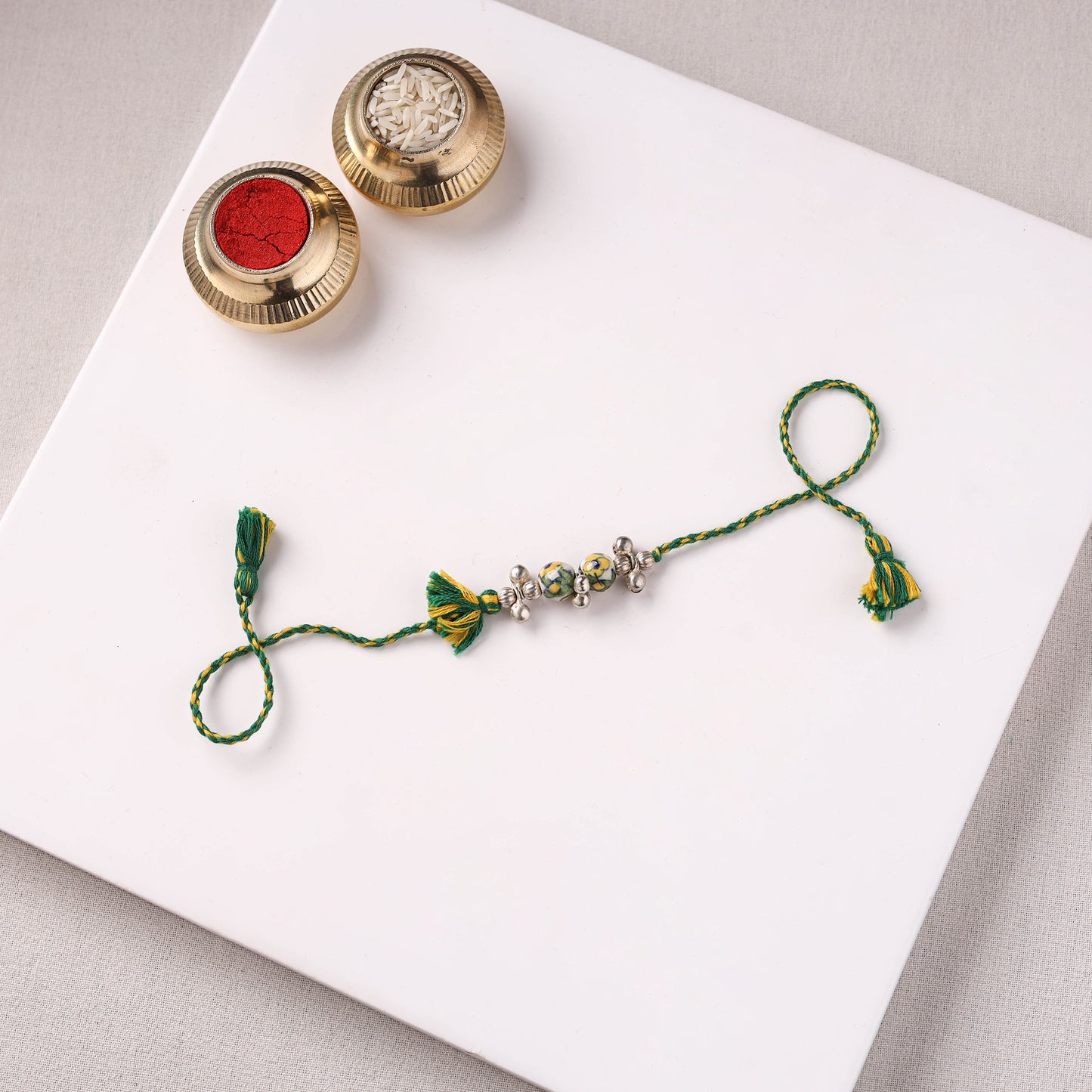 Handcrafted Patwa Threadwork Blue Pottery Beads Rakhi with Potli 04