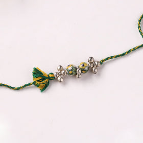 Handcrafted Patwa Threadwork Blue Pottery Beads Rakhi with Potli 04