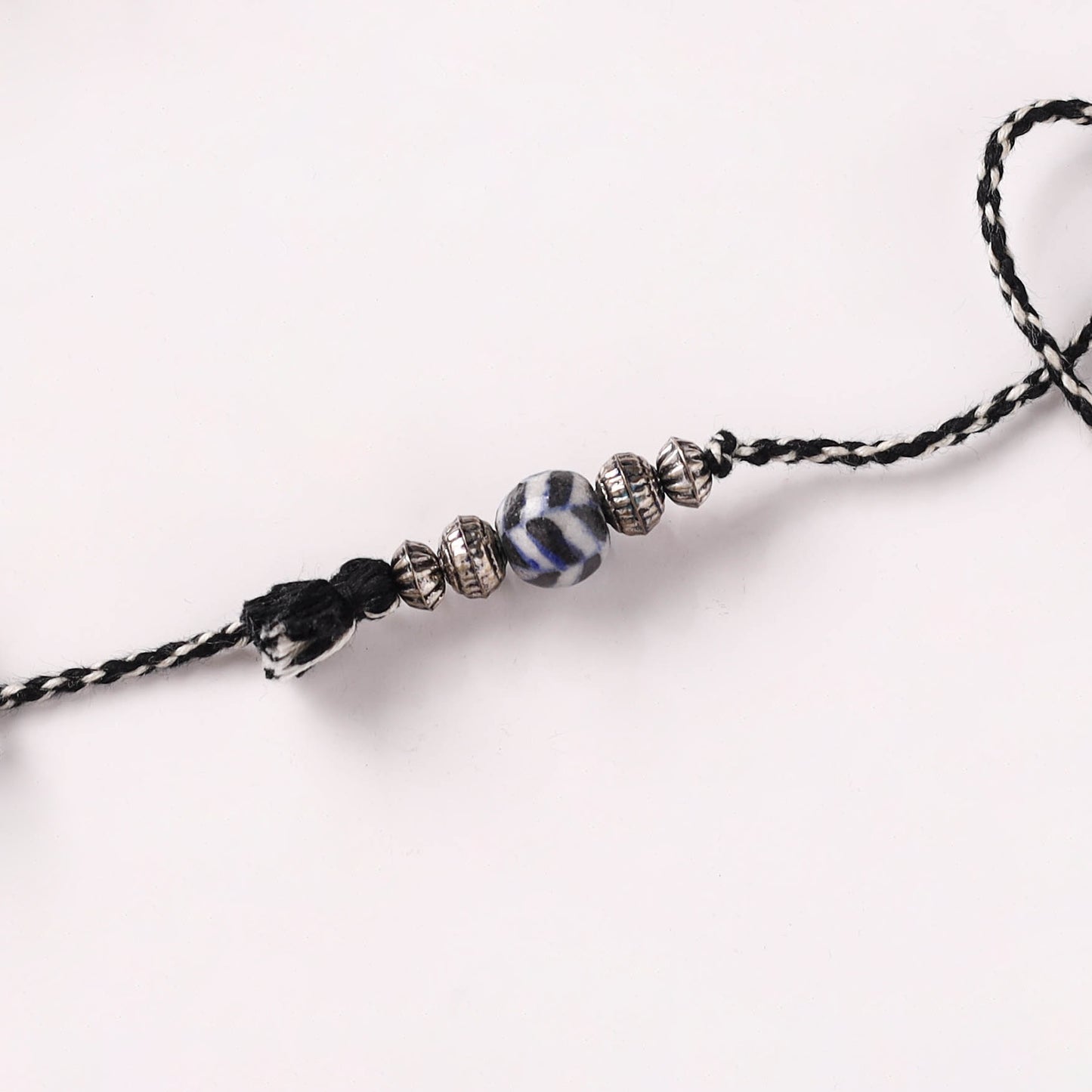 Handcrafted Patwa Threadwork Blue Pottery Beads Rakhi with Potli 05