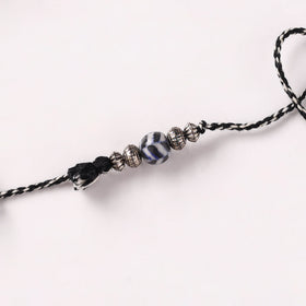Handcrafted Patwa Threadwork Blue Pottery Beads Rakhi with Potli 05