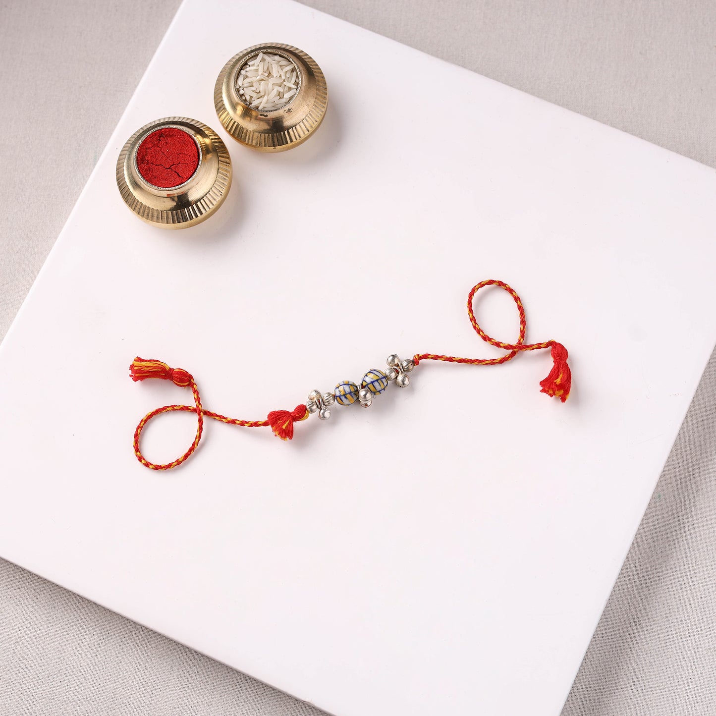 Handcrafted Patwa Threadwork Blue Pottery Beads Rakhi with Potli 07
