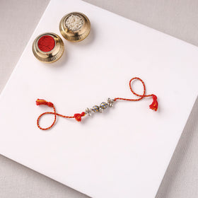 Handcrafted Patwa Threadwork Blue Pottery Beads Rakhi with Potli 07