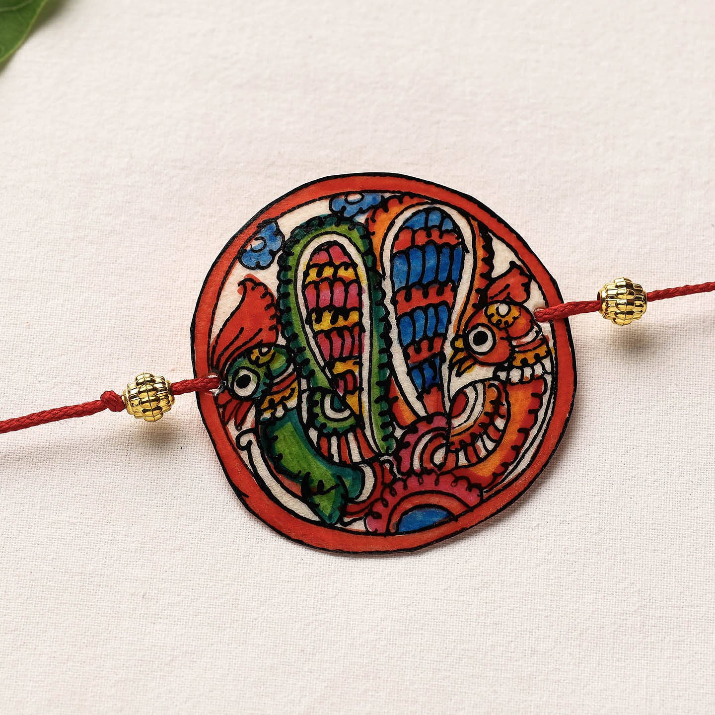 Handpainted Tholu Bommalata Leather Rakhi