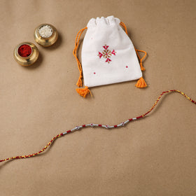 Anant Raksha Thread Work Rakhi with Soof Hand Embroidered Potli 01