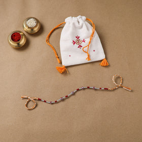 Anant Raksha Thread Work Rakhi with Soof Hand Embroidered Potli 07
