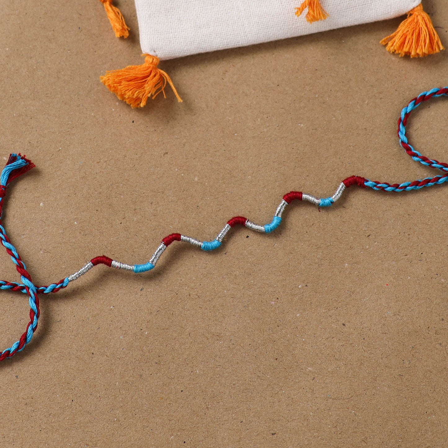 Anant Raksha Thread Work Rakhi with Soof Hand Embroidered Potli 37