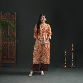 Front view of the cream batik kurta, straight to the knee, casual wear over brown palazzos