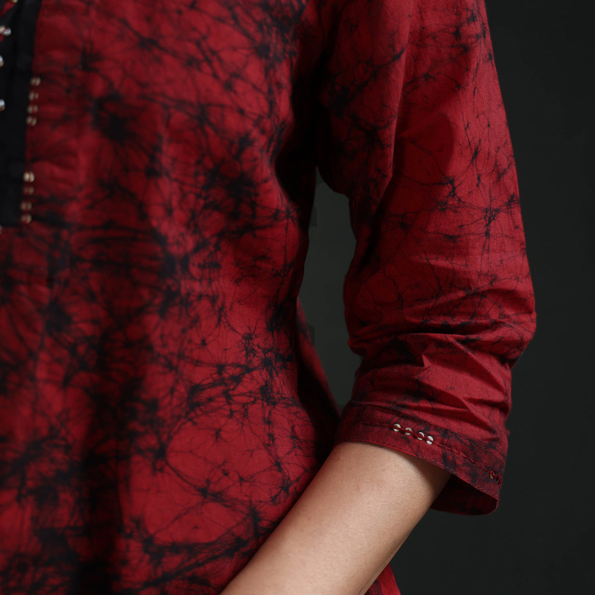 Cuff detail of the maroon kurta: silver sequin dots and black crackle lines