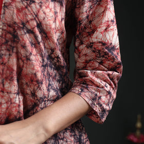 Sleeve with a small bead at the cuff, showing the pink and navy web print of the cream kurta