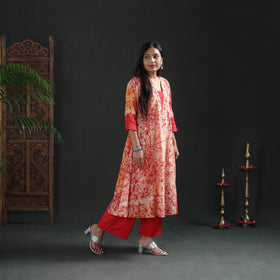 Front three-quarter view of the cream A-line kurta over red straight pants, casual wear