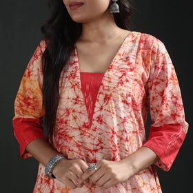 Deep V neckline with its red inset and the sleeve of the cream batik cotton kurta