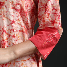 Red cuff panel with pale dashes and the crackled print on the sleeve of the cream kurta